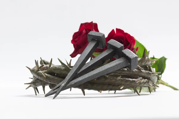 Jesus Christ crown of thorns, nails and two roses. — Stock Photo, Image