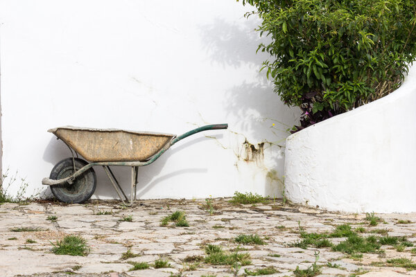 old muddy garden wheelbarrow