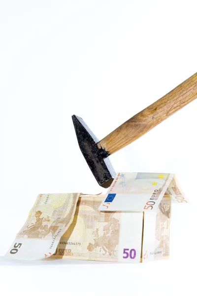 Money-house made of banknotes and hammer — Stock Photo, Image