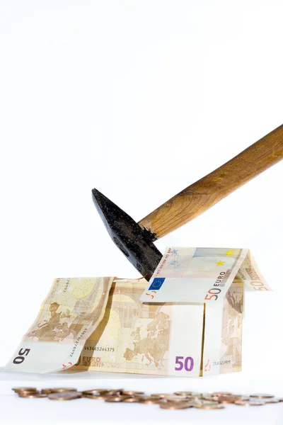 Money-house made of banknotes, coins and hammer — Stock Photo, Image