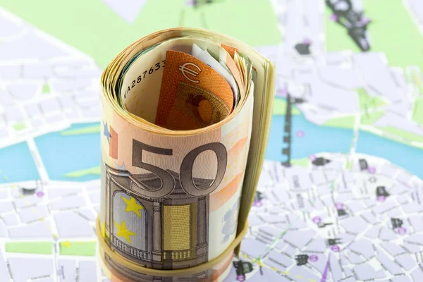 Fifty Euro rolled up on a map as a background — Stock Photo, Image