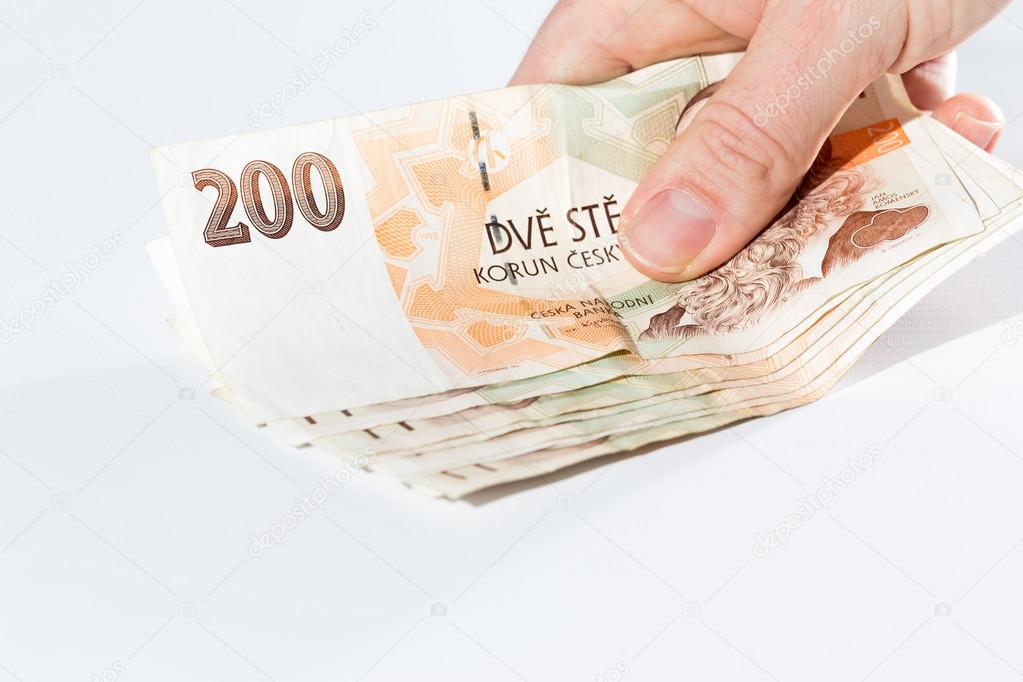 Male hand holding czech banknotes