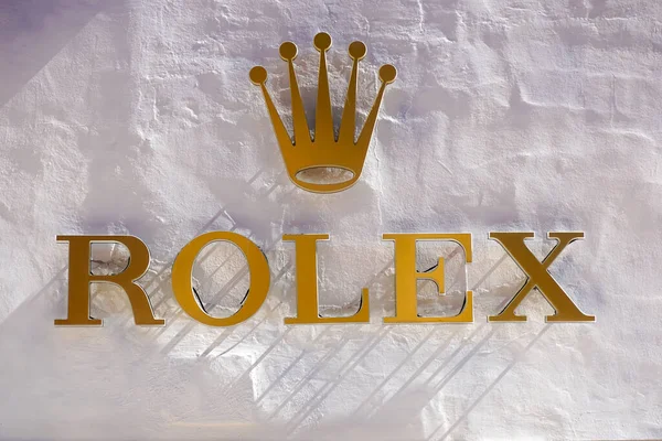 РИМ, ИТАЛИЯ - 10 ДЕКАБРЯ 2020: логотип Rolex на улице. Rolex является производителем высококачественных роскошных наручных часов. Торговая марка зарегистрирована в 1908 году в Швейцарии Лицензионные Стоковые Фото