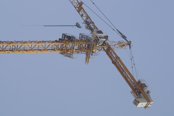 Arm of crane within a construction site