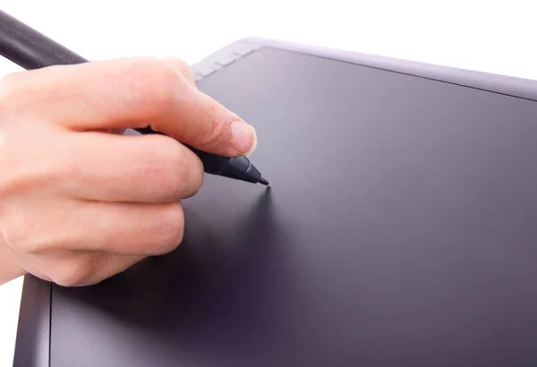 Close up of a hand holding a pen and drawing on a tablet surface retouching, drawing or making a graphic design