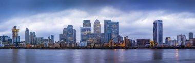 Panoramic skyline of Canary Wharf, the worlds leading financial district at blue hour - London, UK clipart