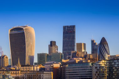 England, UK - Bank. The world famous business district of London with skyscrapers and clear blue sky clipart