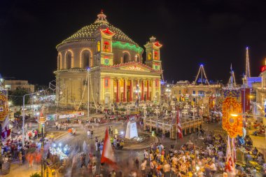 MOSTA, MALTA - 15 AUG. 2016: Mosta festival at night with the famous Mosta Dome at it's full shine. The People of Malta are celebrating the Feast of the Assumption of 'Santa Maria'.