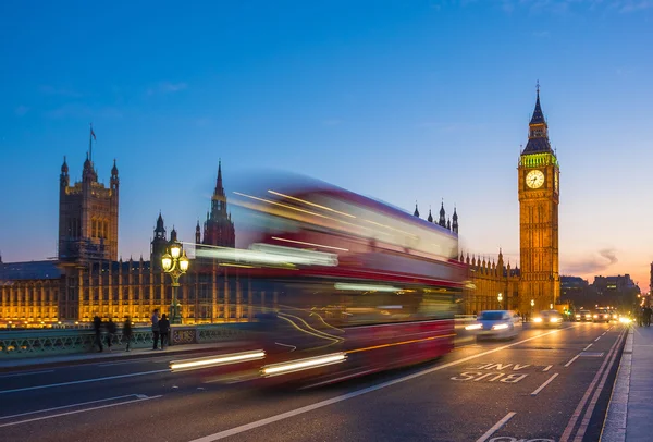 Iconic Double Decker bus with Big Ben and Parliament at blue hour, London, UK