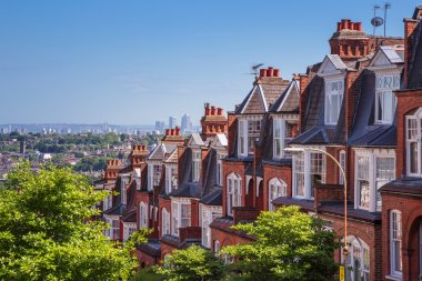 Brick houses of Muswell Hill and panorama of London with Canary Wharf, London, UK