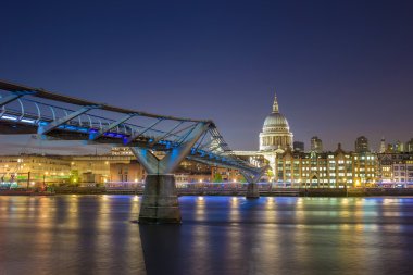 St Paul's Cathedral and the Millennium Bridge by night, London, UK clipart