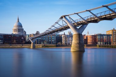 St Paul's Cathedral and Millennium Bridge in sunset, London, UK clipart