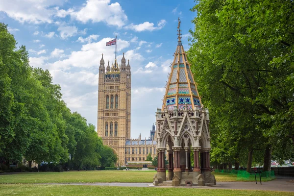 Victoria Tower (Houses of Parliament) and Buxton Memorial Fountain shot from Victoria Tower Gardens, London, UK