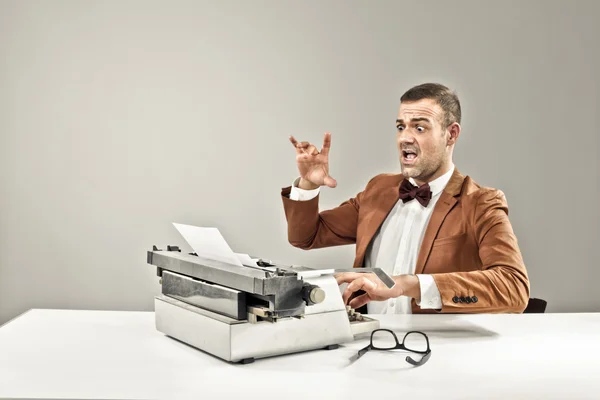 Journalist is writing on his typewriter Stock Image