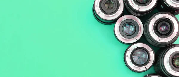 Several Photographic Lenses Lie Bright Turquoise Background Space Text — Stock Photo, Image