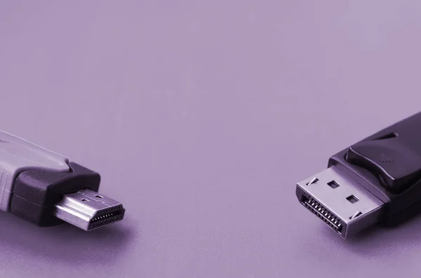 Audio video HDMI computer cable plug and 20-pin male DisplayPort gold plated connector for a flawless connection on a purple background