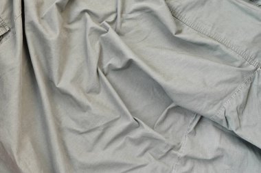 Kumaşın dokusu zeytin renginde, bu da İkinci Dünya Savaşı 'ndaki Amerikan askerlerinin üniformasına benziyor. Askeri tasarım için arkaplan resmi.