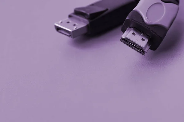 Audio video HDMI computer cable plug and 20-pin male DisplayPort gold plated connector for a flawless connection on a purple background