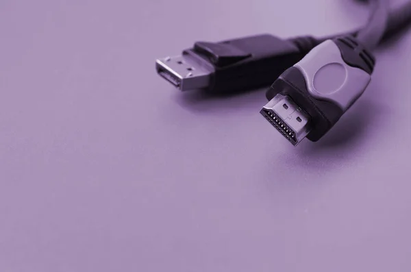 Audio video HDMI computer cable plug and 20-pin male DisplayPort gold plated connector for a flawless connection on a purple background