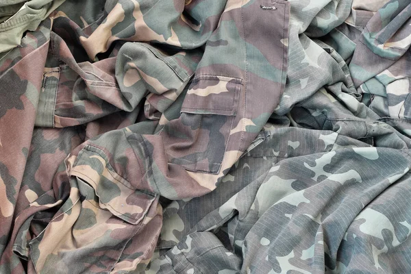 Camouflage background texture as backdrop for russian or ussr snipers design projects. Back side of snipers camouflage jacket with many pleats on crumpled fabric