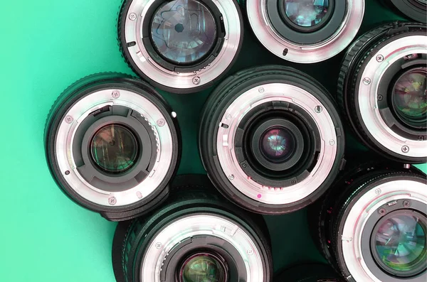 Several Photographic Lenses Lie Bright Turquoise Background Space Text — Stock Photo, Image