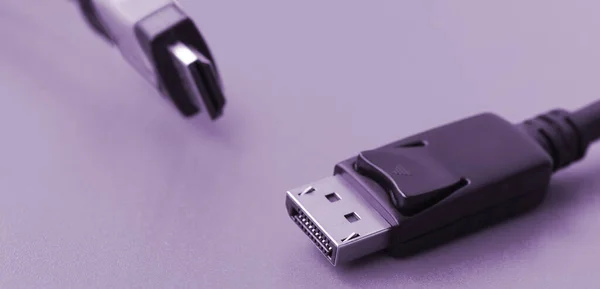 Audio video HDMI computer cable plug and 20-pin male DisplayPort gold plated connector for a flawless connection on a purple background