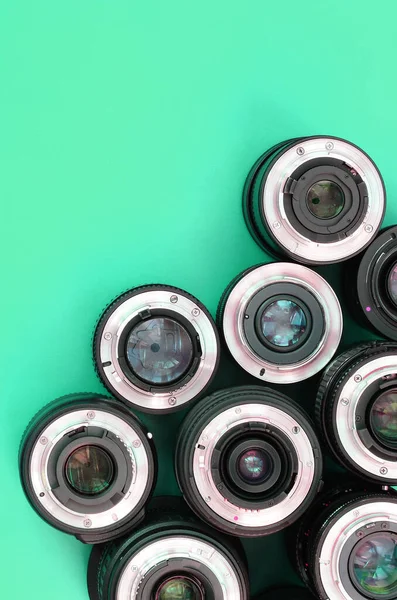 Several Photographic Lenses Lie Bright Turquoise Background Space Text — Stock Photo, Image