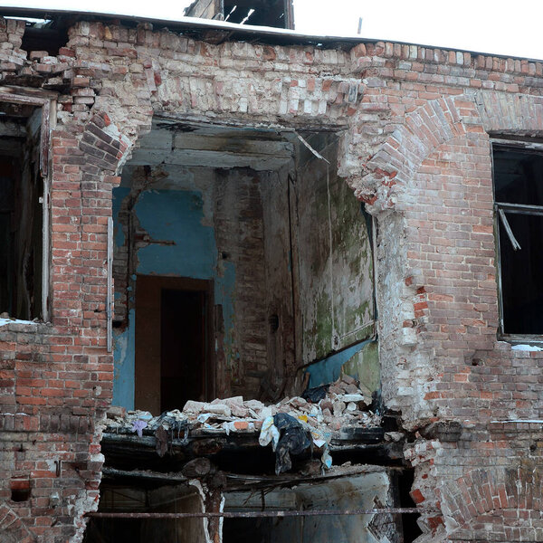Fragment of an abandoned two-story building after military operations in Donetsk region