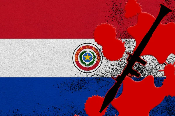 Paraguay flag and black RPG-7 rocket-propelled grenade launcher in red blood. Concept for terror attack or military operations with lethal outcome. Dangerous projectile weapon usage