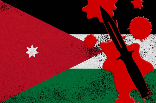 Jordan flag and black tactical knife in red blood. Concept for terror attack or military operations with lethal outcome. Dangerous melee weapon usage