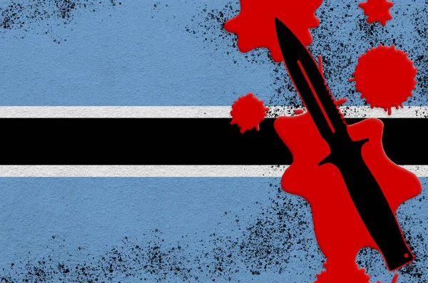 Botswana flag and black tactical knife in red blood. Concept for terror attack or military operations with lethal outcome. Dangerous melee weapon usage