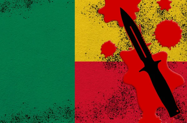 Benin flag and black tactical knife in red blood. Concept for terror attack or military operations with lethal outcome. Dangerous melee weapon usage