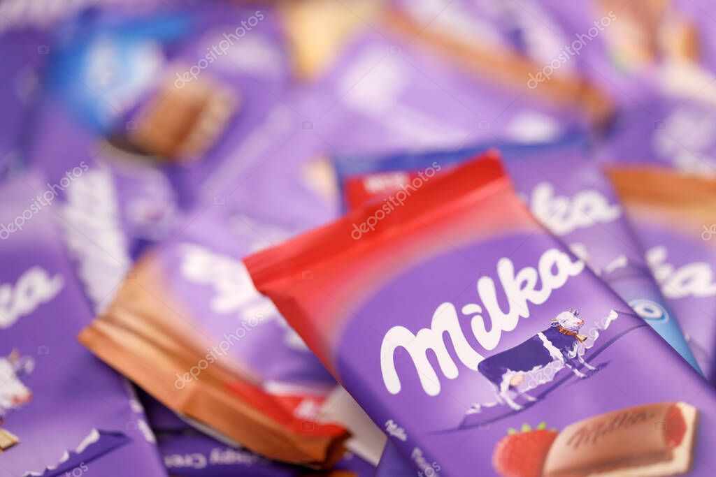KHARKOV, UKRAINE - DECEMBER 8, 2020: Many wrappings of purple Milka chocolate. Milka is a Swiss brand of chocolate confection manufactured internationally by company Mondelez International