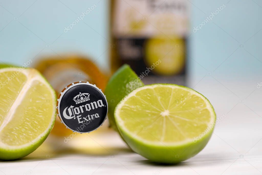 KHARKOV, UKRAINE - DECEMBER 9, 2020: Bottles of Corona Extra Beer with lime slices. Corona produced by Grupo Modelo with Anheuser Busch InBev is the most popular imported beer in the US