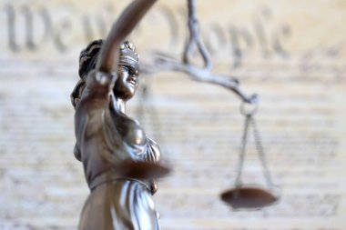 Lady Justice bronz heykeli ve ABD Anayasası sayfasını kapatmış. Amerika Birleşik Devletleri 'nde dava ve adalet
