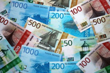 Norwegian Krone currency money bills. NOK currency banknotes in heap with different denomination close up