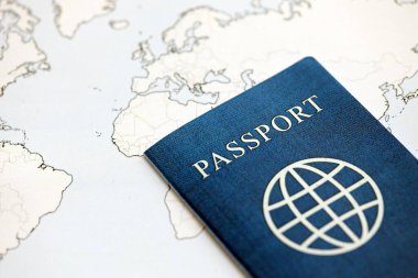 Generic Passport lies on world map close up. Concept of travel and tourism around the world