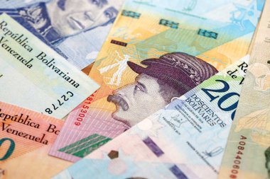 Venezuelan Bolivar currency money bills in big amount. Heap of VED currency banknotes with different denomination close up