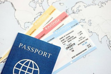 Generic Passport and boarding pass tickets on world map close up. Concept of travel and tourism around the world