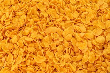 Mısır gevreği arkaplanı ve dokuyu kapatır. Sabah kahvaltısı için mısır gevreği.