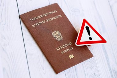 Beyaz ahşap arka planda ünlem işareti olan Avusturya pasaportu. Avrupa konseptinde vatandaşlık sorunları