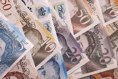 KYIV, UKRAINE - SEPTEMBER 17, 2025 Big amount of British pound money bills on table close up