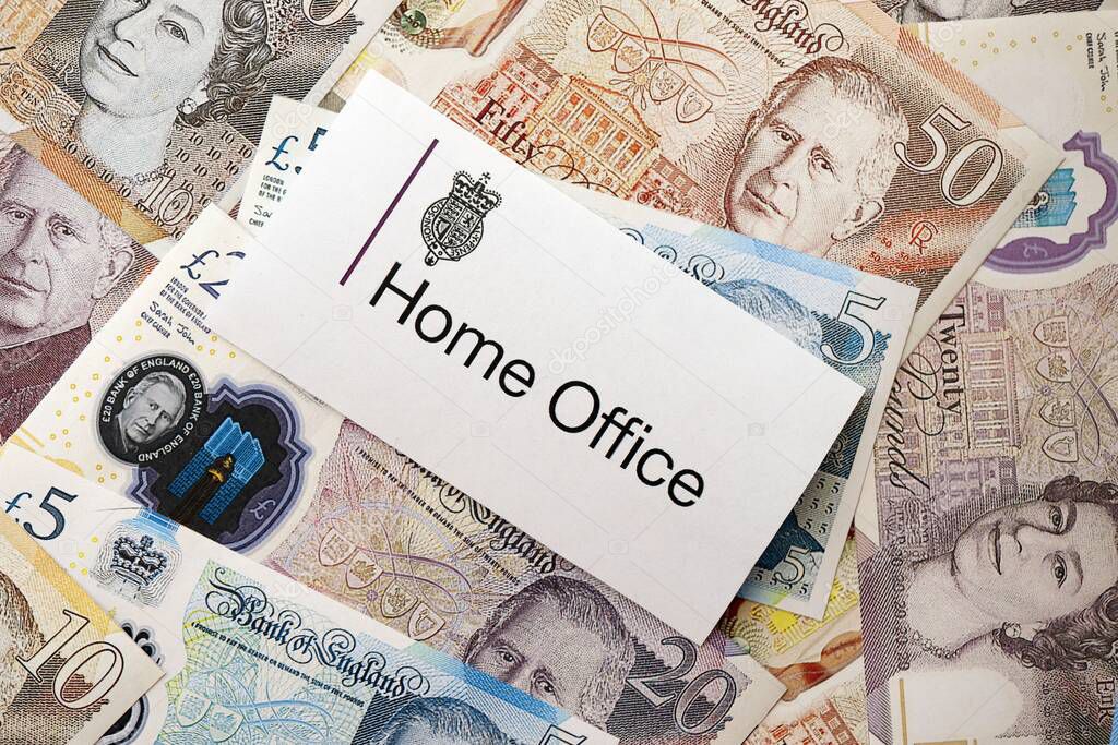 KYIV, UKRAINE - SEPTEMBER 17, 2025 UK Home Office logotype sticker lies on British Union Jack flag close up