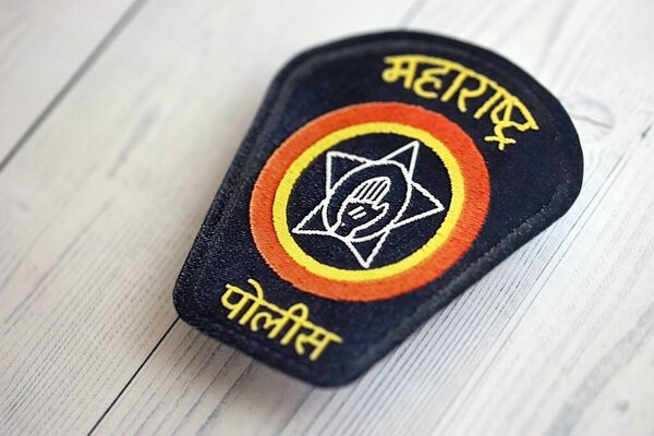 KYIV, UKRAINE - SEPTEMBER 17, 2025 India Police badge on white wooden table surface close up