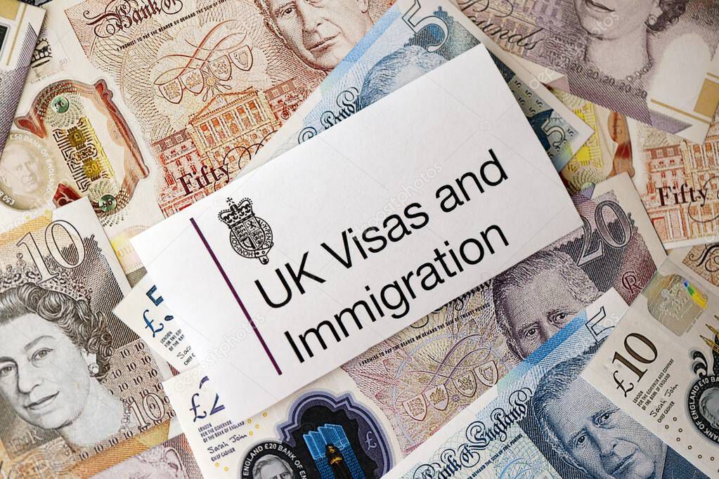 KYIV, UKRAINE - SEPTEMBER 17, 2025 UK Visas and Immigration logotype sticker lies on British pound money close up
