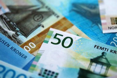 Norwegian Krone currency money bills. NOK currency banknotes in stack with different denomination close up