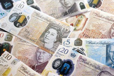 KYIV, UKRAINE - SEPTEMBER 17, 2025 Big amount of British pound money bills on table close up