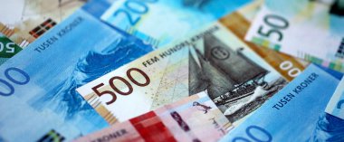 Norwegian Krone currency money bills. NOK currency banknotes in stack with different denomination close up