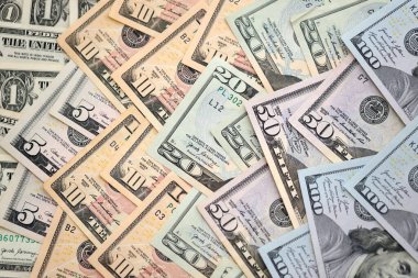 United States Dollar currency money bills. USD currency banknotes in pile with different denomination close up