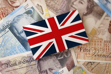 KYIV, UKRAINE - 17 Eylül 2025 Büyük miktarda İngiliz sterlini ve İngiliz bayrağı